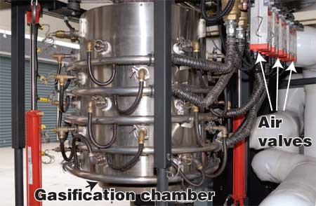 Photo of a large silver tank with several hoses coming off the tank.