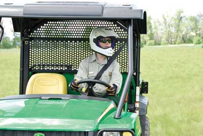 Photograph of an operator of an UTV looking to thier left.