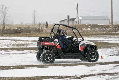 Photograph of students practicing on the driving course in a UTV.