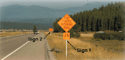 Photo of a roadway with a series of two orange signs.  The first is orange and diamond-shaped and reads, Fire Traffic Entering Road.  Below this sign is a smaller square-shaped sign that reads, 35 MPH.  The second sign in the series is orange and rectangle-shaped but too small to read.