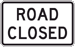White rectangular-shaped sign with black text that reads, Road Closed.
