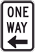 Rectangular-shaped black and white sign that reads, One Way.  Below the text is an arrow pointing left.