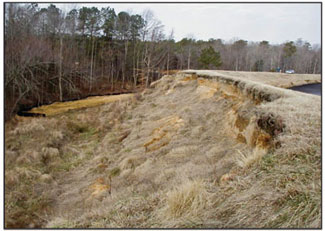 Image of where the side of a dam has slumped.