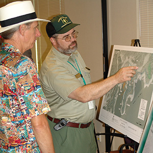 uniformed Forest Service representative discussing a recreation project with a citizen.