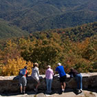 Visitors enjoy the fall colors while taking a moment to gaze across the landscape from the Wayah Fire Tower on the Nantahala National Forest in North Carolina. (U.S. Forest Service)