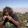 Lichenologist using a hand-lens to identify a lichen